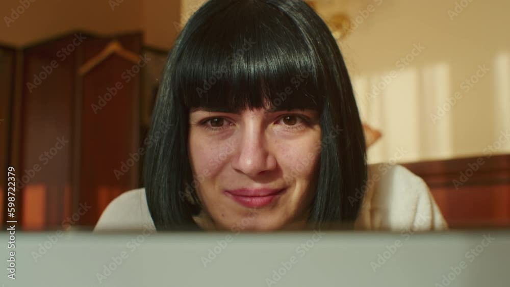 Experience the joys of working from home with this video, as a young woman uses her laptop and email to handle business tasks while sitting on her cozy sofa during quarantine. Experience the joys of working from home with this video, as a young woman uses her laptop and email to handle business tasks while sitting on her cozy sofa during quarantine.
