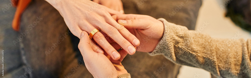 partial view of man wearing wedding ring on gay partner while making marriage proposal, banner. partial view of man wearing wedding ring on gay partner while making marriage proposal, banner.