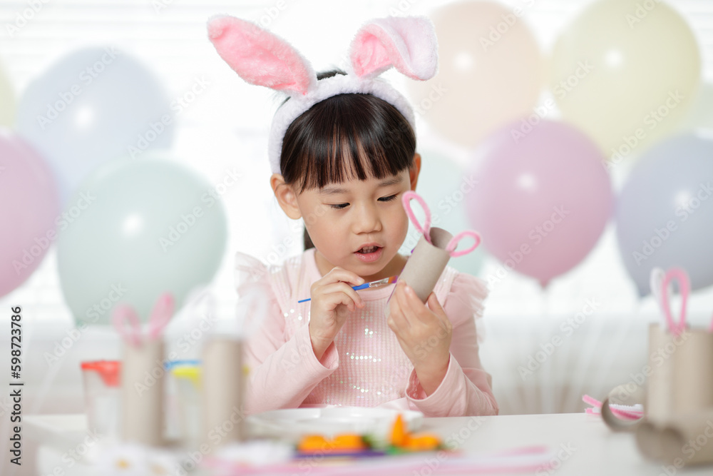 young girl making easter craft at home