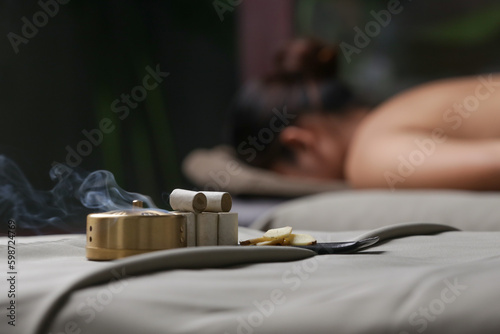 Moxibustion treatment - traditional Chinese medicine tools for acupuncture points heating therapy.
Chinese herbal medicine. Moxibustion copper burner box with moxa herbal sticks in holistic spa. 