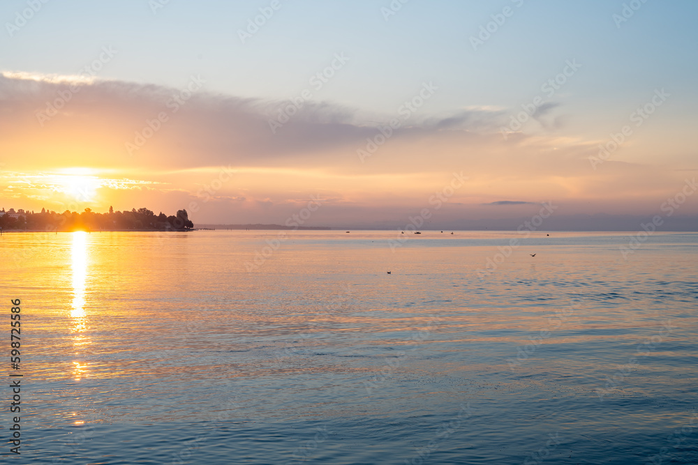 Beautiful sunrise view from Imperia statue at harbor entrance on lake Constance in early morning hours. Steamer harbor, Constance, Baden-Württemberg, Germany, Europe.