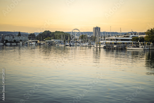 Beautiful sunrise view from Imperia statue at harbor entrance on shorefront, girant wheel and Sealife in early morning hours. Steamer harbor, Constance, Baden-Württemberg, Germany, Europe. © Michael