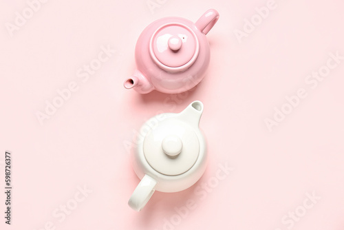 Different teapots on pink background