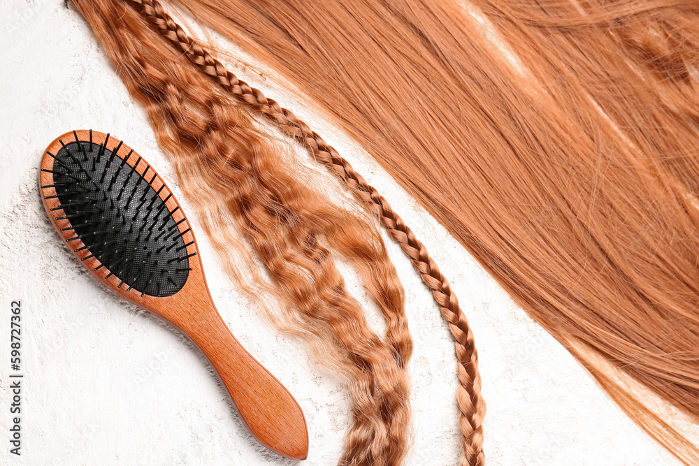 Beautiful ginger hair with brush on white background Beautiful ginger hair with brush on white background