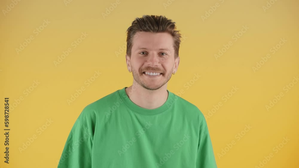 Front view of happy smiling young man wearing green t-shirt isolated on yellow background Generative AI Front view of happy smiling young man wearing green t-shirt isolated on yellow background Generative AI