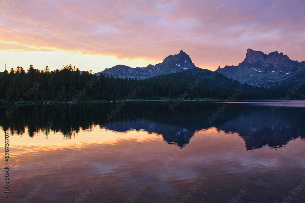 Pink sunset on Svetloye lake. Ptitsa and Zvezdnyy peaks in mountain nature park Ergaki, Krasnoyarsk region, Siberia