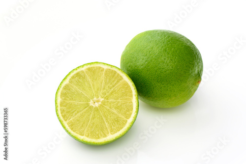 whole lime and sliced ​​lime on white background with shadows