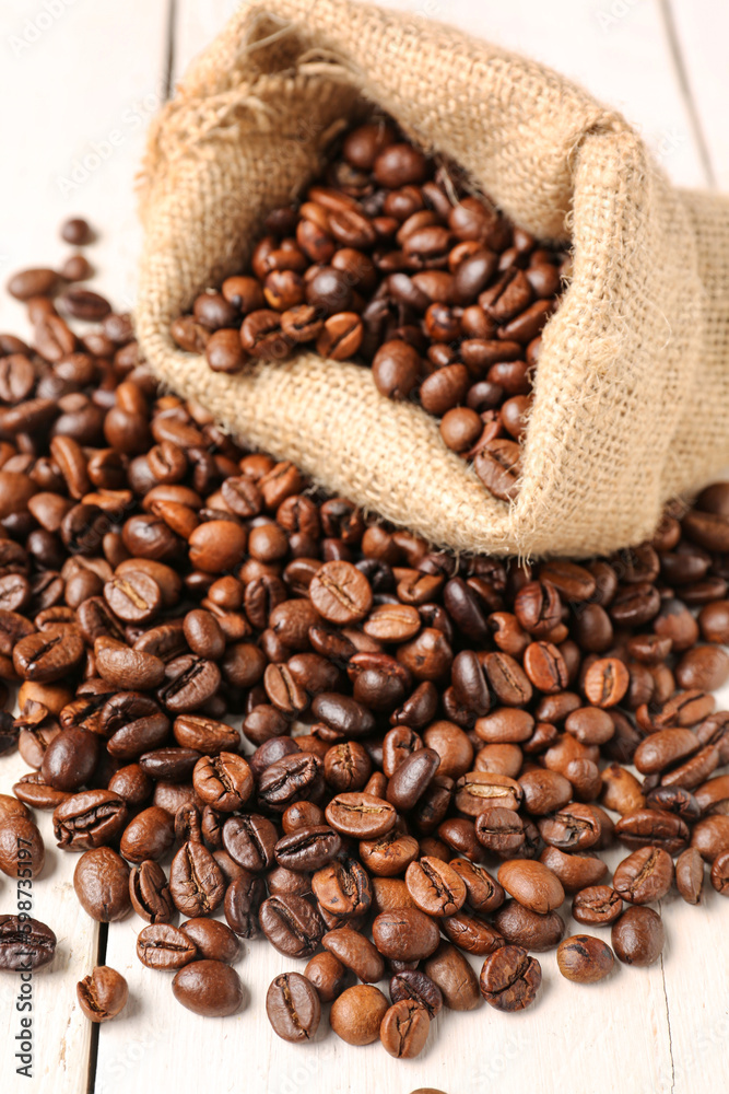 Bag with coffee beans on light wooden background Bag with coffee beans on light wooden background