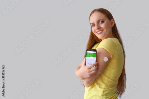 Woman with glucose sensor u...