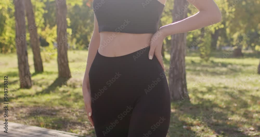 A young girl shows her athletic figure in the rays of the summer sun. A young girl shows her athletic figure in the rays of the summer sun.