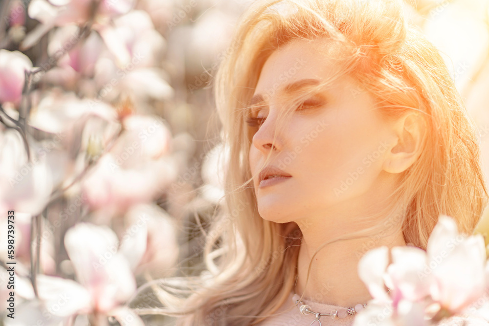 Magnolia woman portrait. Happy middle aged woman enjoying the smell in a blooming spring garden. Beautiful magnolia bushes, large flowers. Magnolia woman portrait. Happy middle aged woman enjoying the smell in a blooming spring garden. Beautiful magnolia bushes, large flowers.