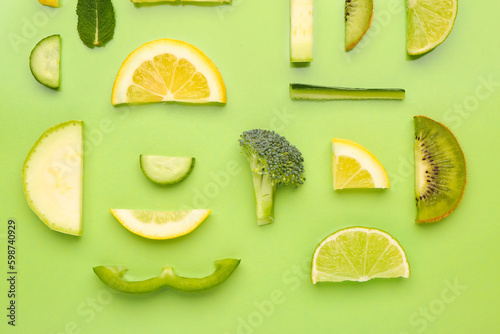 Fototapeta Naklejka Na Ścianę i Meble -  Composition with different fresh fruits and vegetables on green background