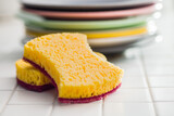 Sponge for washing dishes and plates on tiles.