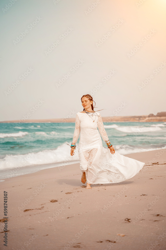 woman sea white dress. Model in boho style in a white long dress and silver jewelry on the beach. Her hair is braided, and there are many bracelets on her arms. woman sea white dress. Model in boho style in a white long dress and silver jewelry on the beach. Her hair is braided, and there are many bracelets on her arms.
