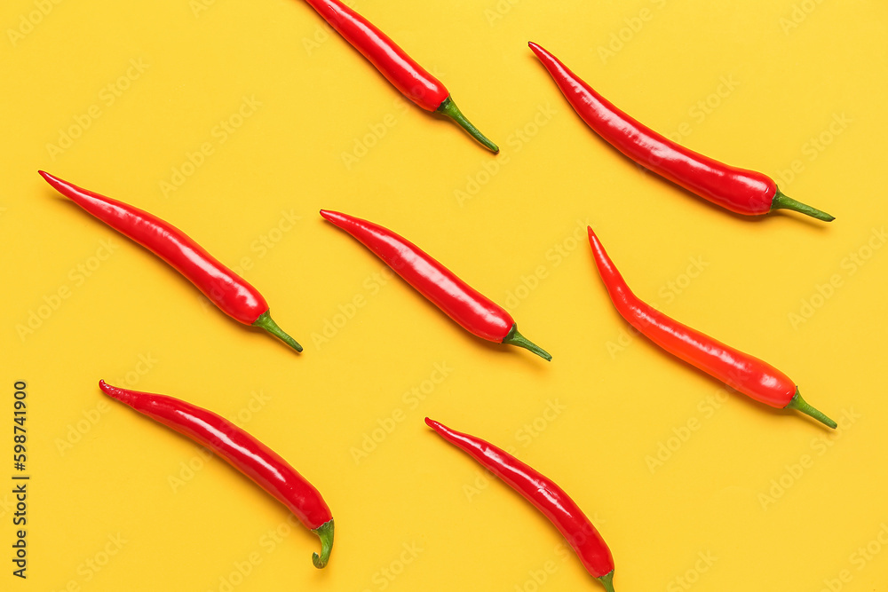 Fresh hot chili peppers on yellow background Fresh hot chili peppers on yellow background