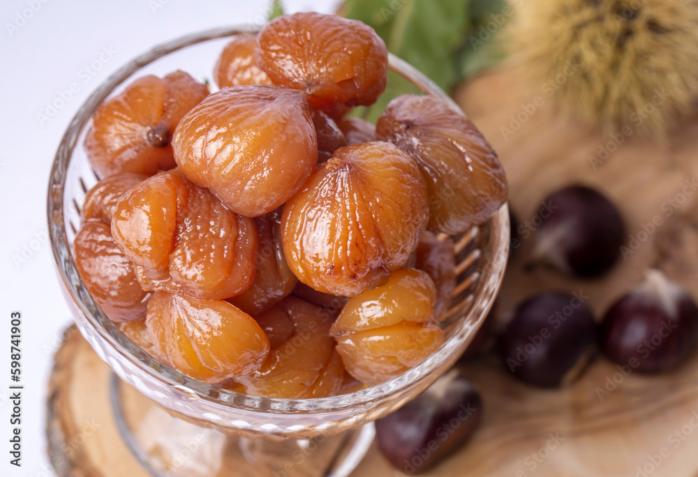 Chestnut dessert and chestnuts on a plate. Traditional delicious Turkish dessert; chestnut candies (Kestane Sekeri) Chestnut dessert and chestnuts on a plate. Traditional delicious Turkish dessert; chestnut candies (Kestane Sekeri)