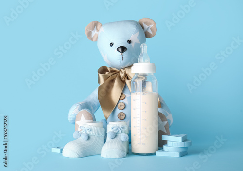 Teddy bear with bottle of m...