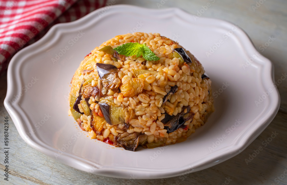 Traditional delicious Turkish food; Bulgur pilaf with eggplant and vegetables. (Turkish name; Patlicanli bulgur pilavi) Traditional delicious Turkish food; Bulgur pilaf with eggplant and vegetables. (Turkish name; Patlicanli bulgur pilavi)
