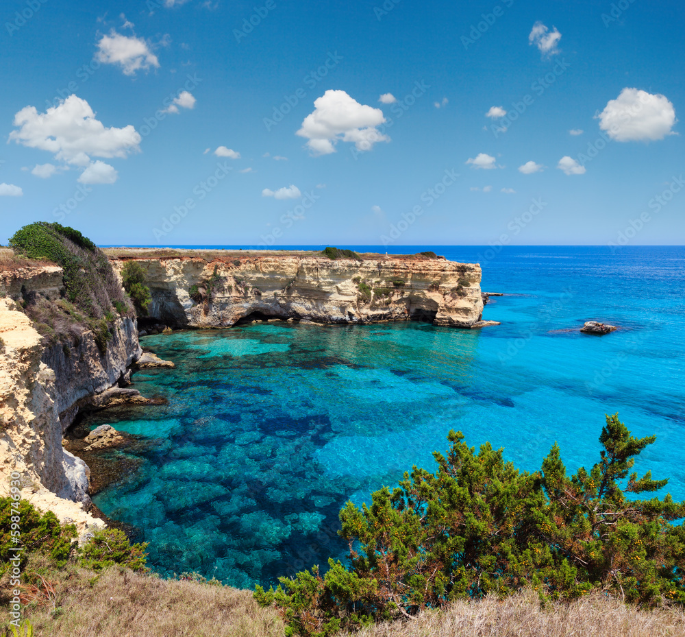 Picturesque seascape with cliffs and rocky arch, at Torre Sant Andrea, Salento sea coast, Puglia, Italy.