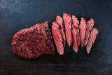 Traditional American barbecue bavette steak with salt and pepper served as top view on a rustic design board with copy space