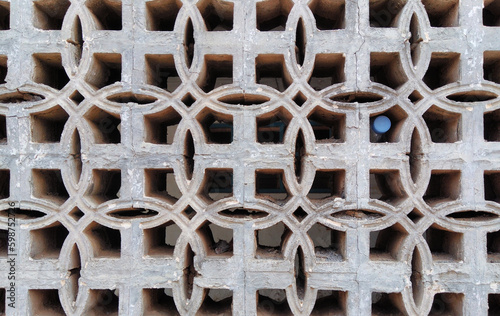 Pattern of wall vent with a plastic bottle in one of the hole. 