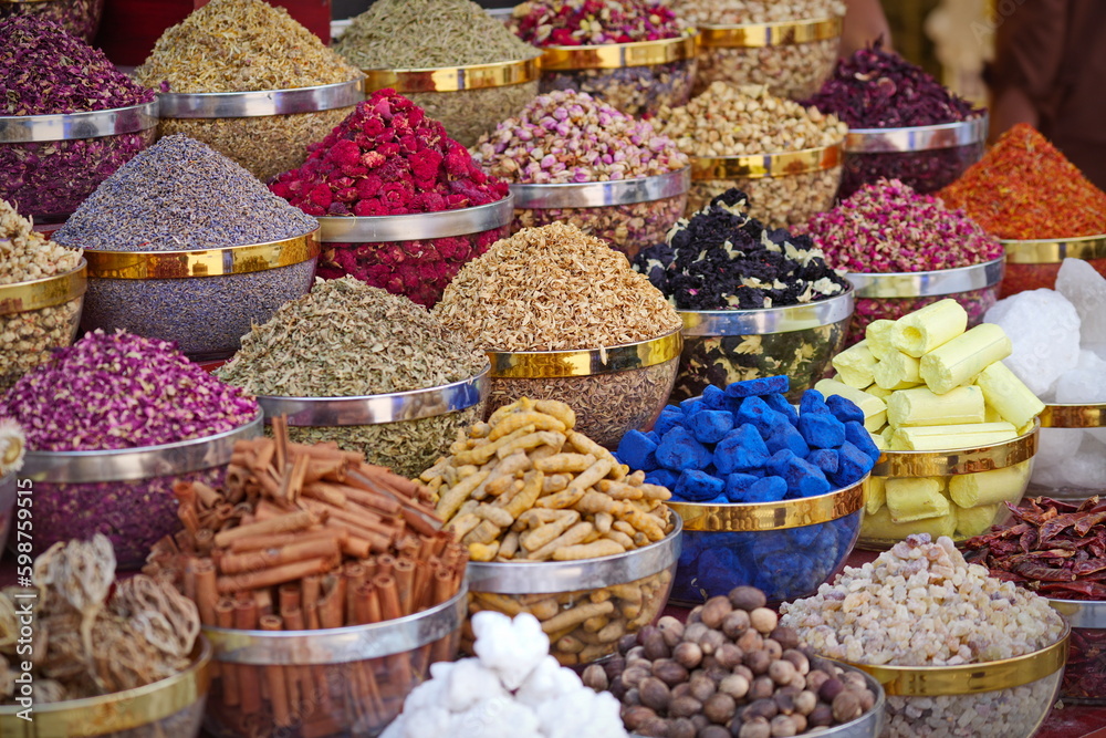 Variety of spices and dried herbs flowers on the arab street market stall. Dubai Spice Souk in Deira, United Arab Emirates.