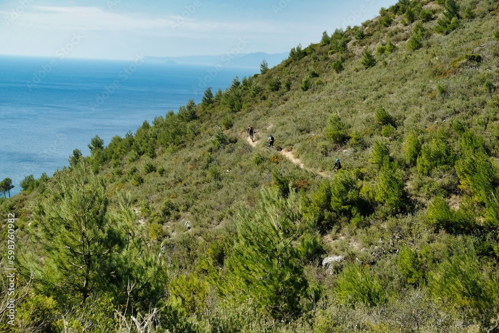 boys on mountain bikes on the hills of Varigotti during a summer day boys on mountain bikes on the hills of Varigotti during a summer day