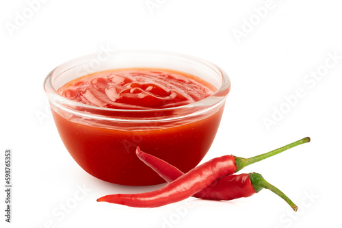 Red chili pepper sauce in glass bowl on white background. photo