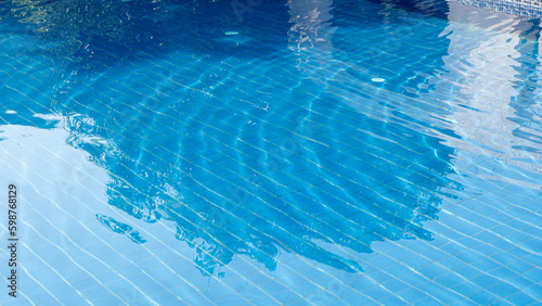 Clear water with gentle waves. Along with beautiful blue swimming pool floor tiles.