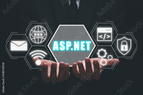 ASP.NET Development programming language concept, Person hand holding ASP.NET icon on virtual screen.