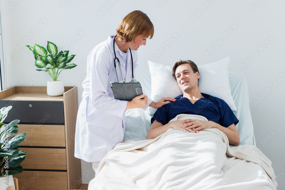 the doctor is examining the patient in the hospital. Caucasian female doctor talking to male patient lying in hospital bed. the doctor is examining the patient in the hospital. Caucasian female doctor talking to male patient lying in hospital bed.