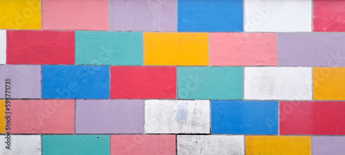 COLOURFUL WALL TILES DESIGN. Grunge style abstract background with a geometric design. brick wall painted in rainbow colors © ADP