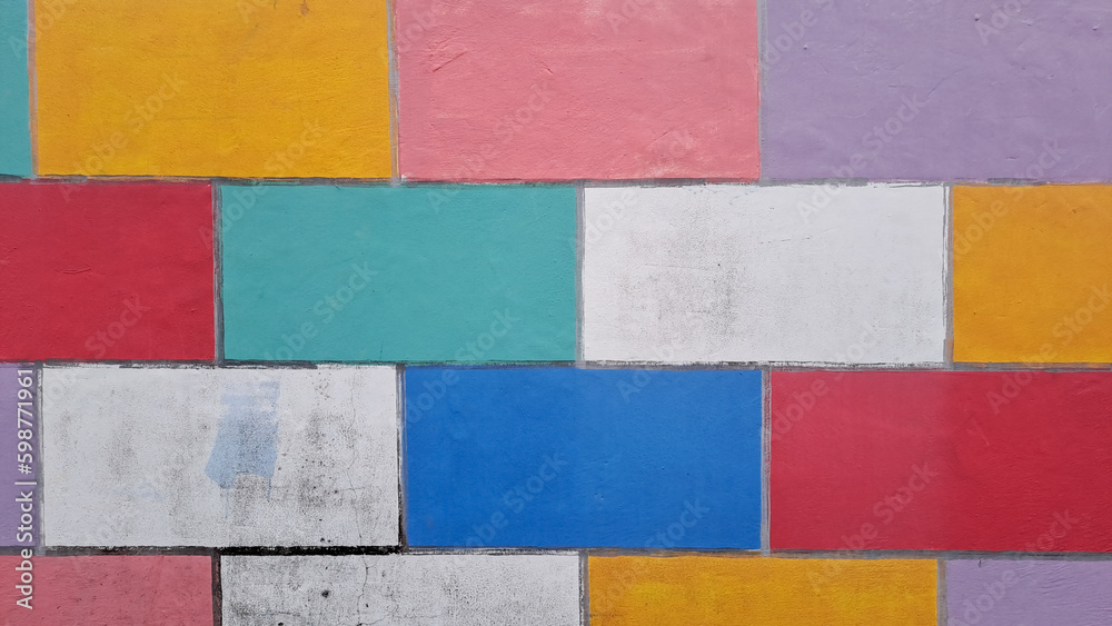 COLOURFUL WALL TILES DESIGN. Grunge style abstract background with a geometric design. brick wall painted in rainbow colors COLOURFUL WALL TILES DESIGN. Grunge style abstract background with a geometric design. brick wall painted in rainbow colors