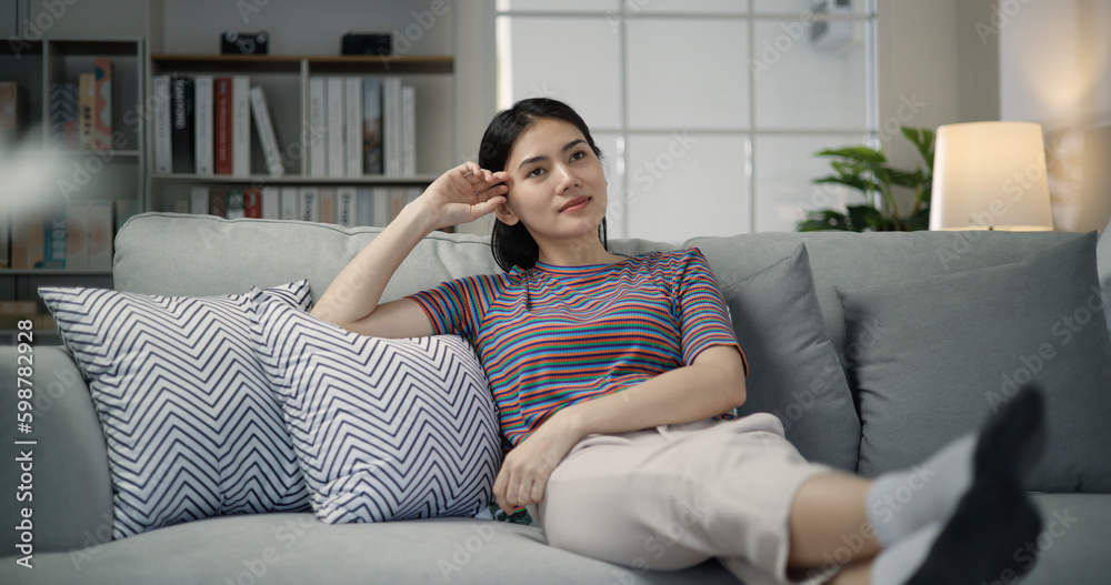 Obraz premium Portrait close-up of young asian female watching television