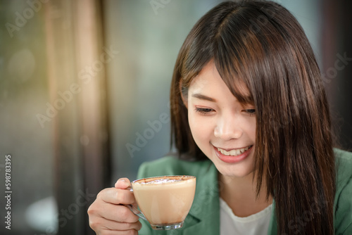 Young woman with a cup of coffee in the office.