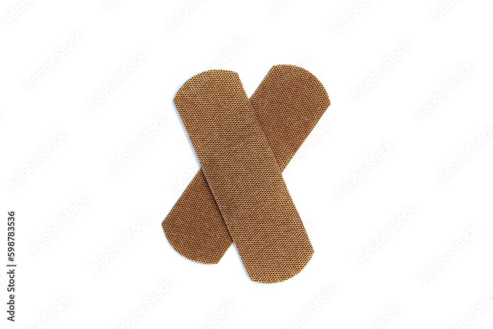 On a white isolated background there is an adhesive plaster in the form of a cross. On a white isolated background there is an adhesive plaster in the form of a cross.