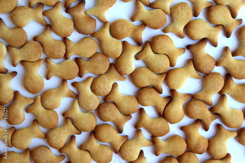 The texture of the cookies scattered on the surface in the form of fish.