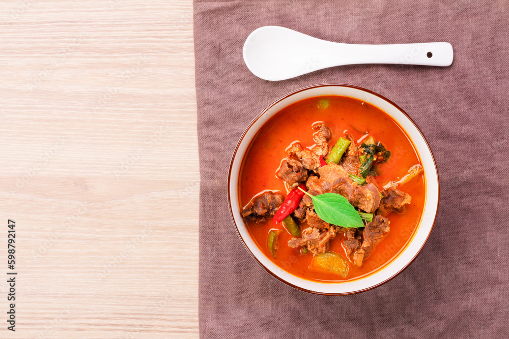 Beef curry, beef panang recipe. Thai food, young coconut milk curry Placed on a wooden table - top view Beef curry, beef panang recipe. Thai food, young coconut milk curry Placed on a wooden table - top view