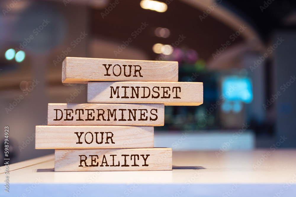 Wooden blocks with words 'Your mindset determines your reality'.