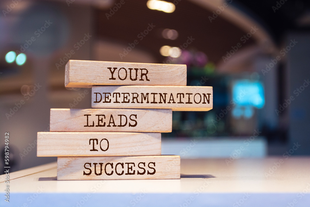 Wooden blocks with words 'Your determination leads to success'.