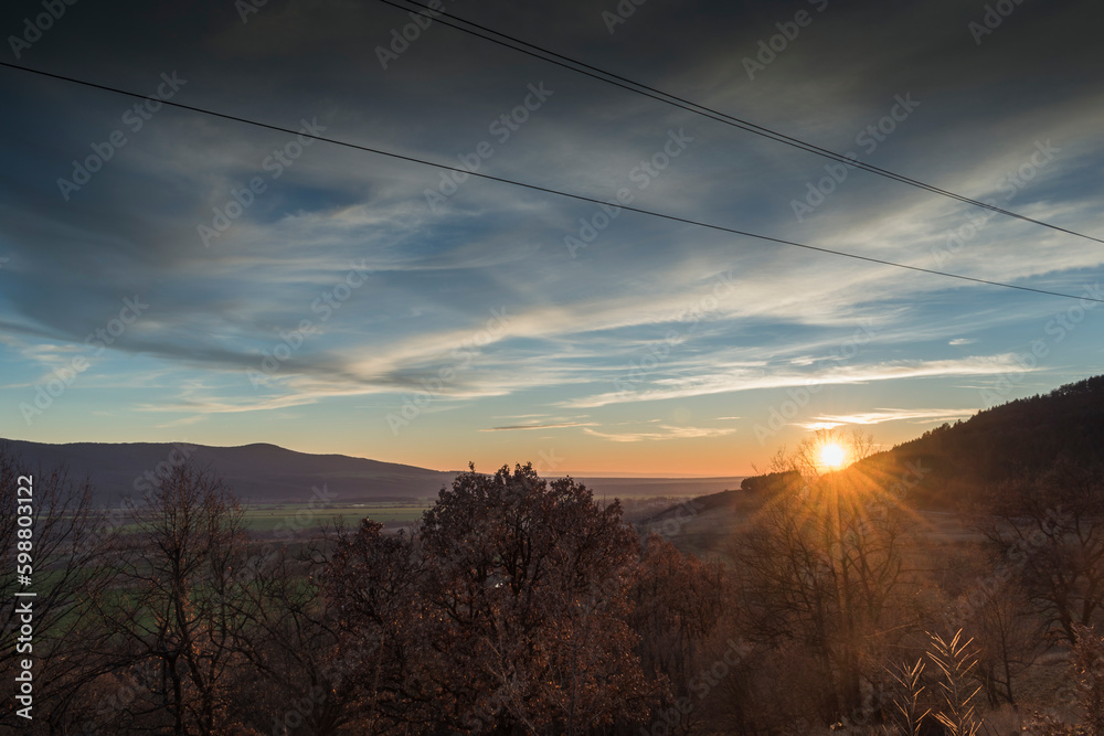 custom made wallpaper toronto digitalA scenic sunset over a wooded area.