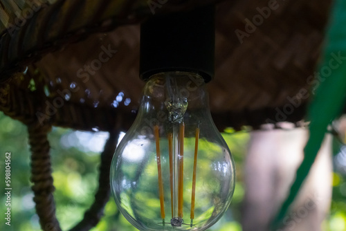 Decor of a festive outdoor banquet. Garland of incandescent lamps in of a loft style