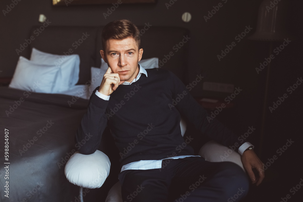 A handsome man sits confidently on a chair in a studio, exuding leadership and poise. His posture and demeanor convey a sense of strength and authority, making him an undeniable leader. A handsome man sits confidently on a chair in a studio, exuding leadership and poise. His posture and demeanor convey a sense of strength and authority, making him an undeniable leader.