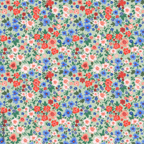 Seamless pattern. Vector flower design with cute wildflowers. Romantic abstract floral pattern on a light green background. Illustrations of spring nature in bright red and blue tones.