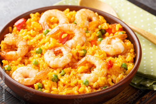 Yellow rice with shrimps arroz con camarones close-up in a bowl on the table. horizontal