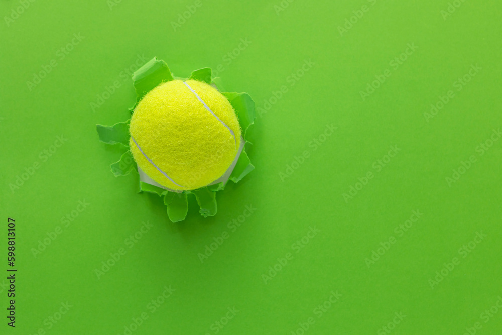tennis ball on torn paper