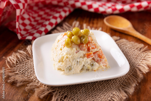 Russian Salad, also known as Olivier Salad. Very popular dish in several countries, the main ingredients are commonly potatoes, mayonnaise and vegetables such as peas, carrots, boiled eggs or chicken photo