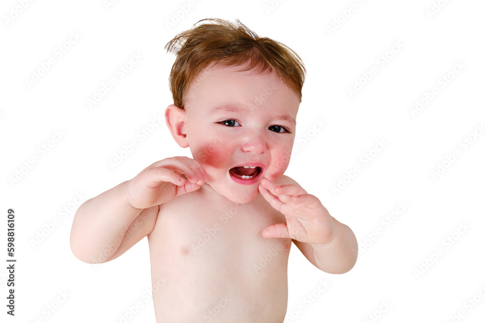 Crying screaming toddler baby boy is lying on the bed, isolated on a white background. Unhappy child close-up on a white blanket, isolated on a white background. Kid aged one year