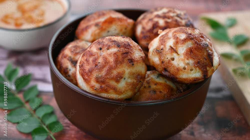 Serving Indian breakfast kuzhi paniyaram in a bowl.
Serving Indian breakfast kuzhi paniyaram in a bowl.