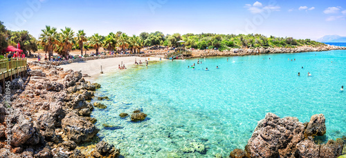 Fototapeta Naklejka Na Ścianę i Meble -  Emerald water and rocky beach at Cleopatra Island, Sedir Island, Aegean Sea, Marmaris, Turkey
